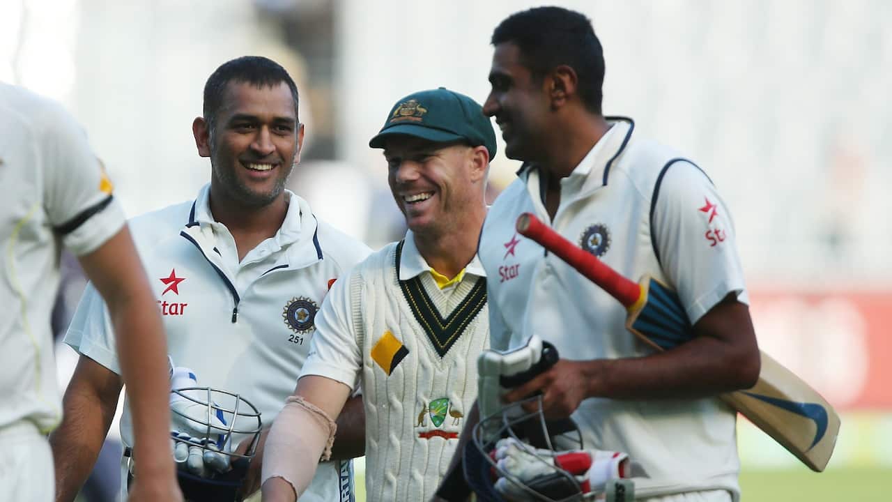 MS Dhoni and Ravichandran Ashwin of India share a joke with David Warner of Australia after a draw on day five of the Third Test match between Australia and India at Melbourne Cricket Ground on December 30, 2014 in Melbourne, Australia.