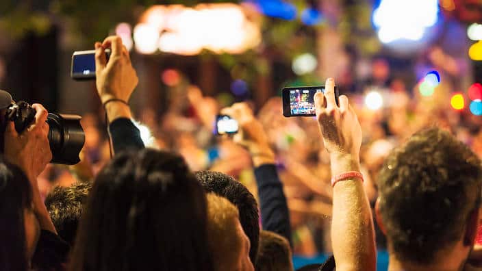 Spectators Photographing an Event