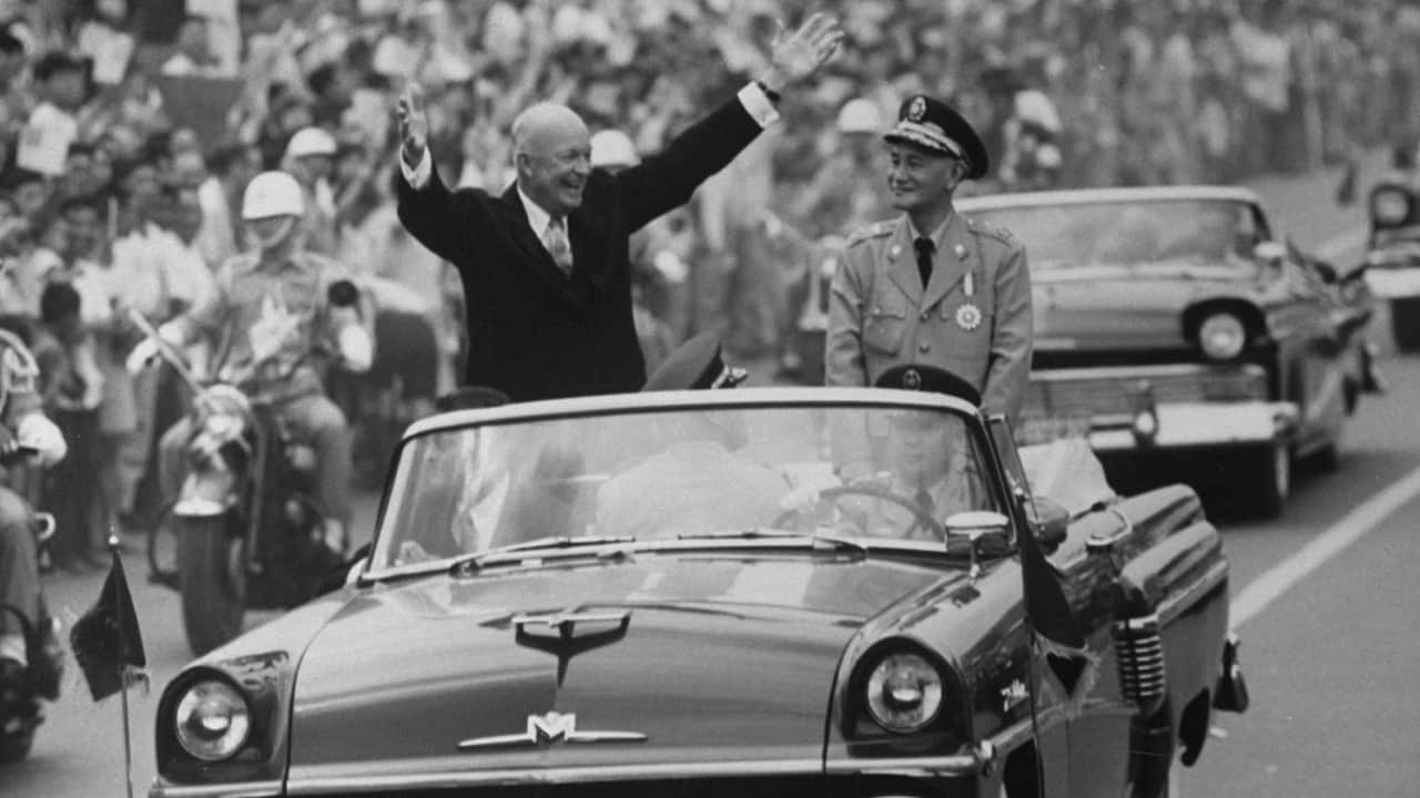 Pres. Dwight D. Eisenhower (L) and Kai Shek Chiang (R) in motorcade during his Eastern good-will tour