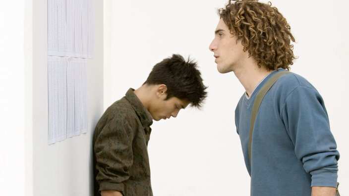 Two students standing near results posted on wall