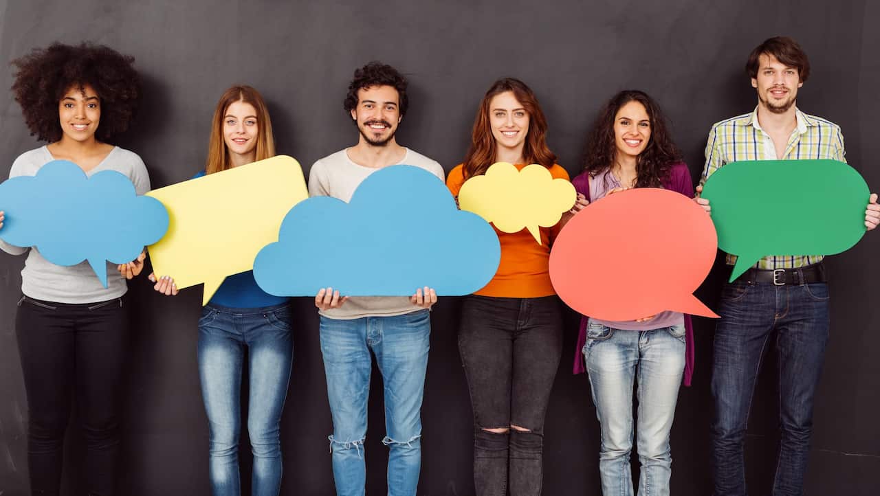 Happy friends holding speech bubbles