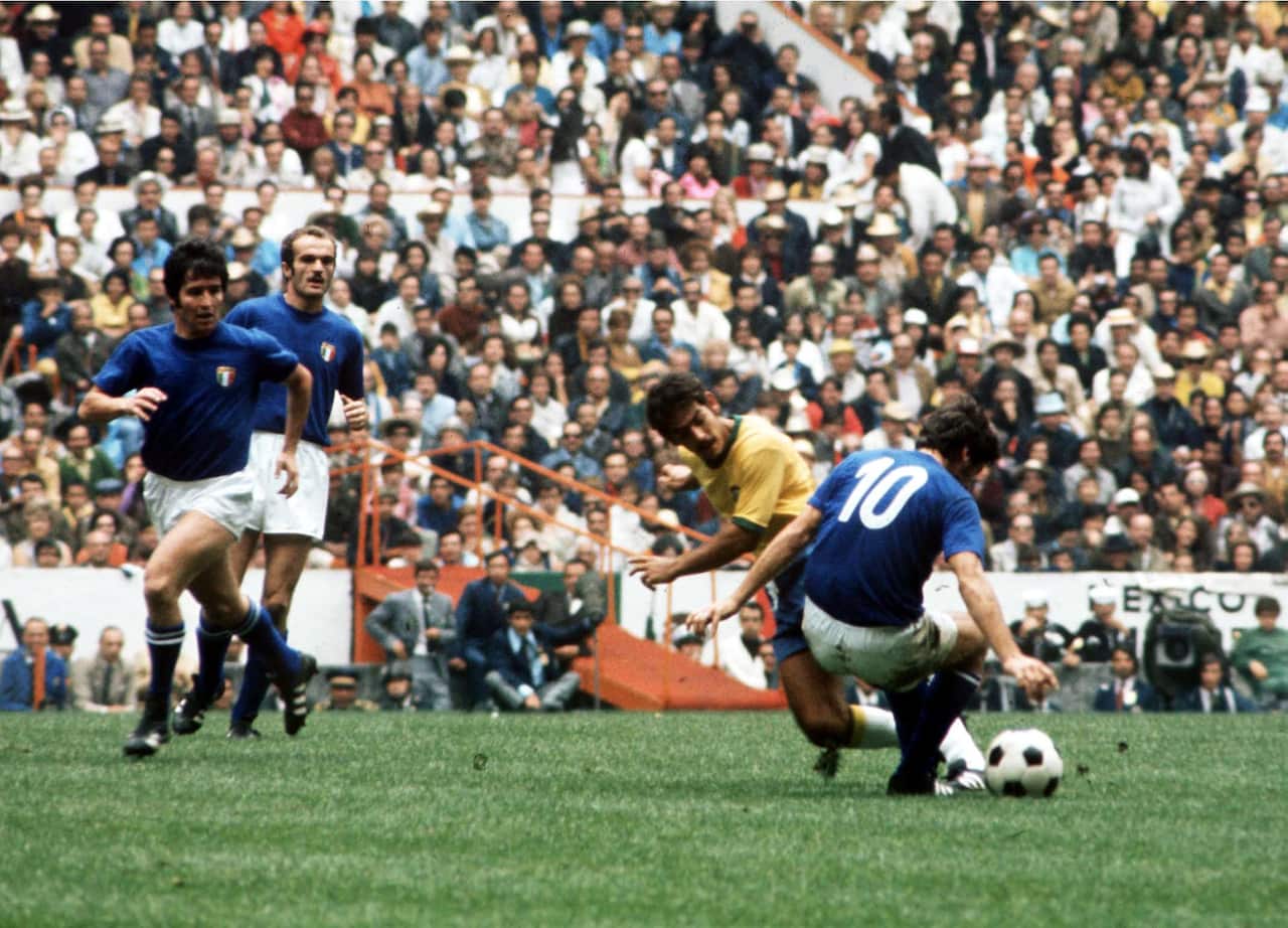 Brazil's Rivelino challenges Italy's Mario Bertini for the ball watched by Giancarlo De Sisti and Sandro Mazzola 