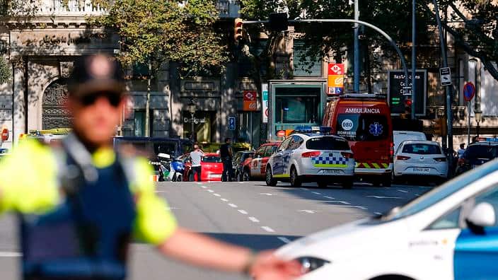 A policemen stand as he blocks the street to a cordoned off area after a van ploughed into the crowd