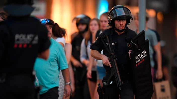 Spanish policemen stand guard in a cordoned off area after a van ploughed into the crowd