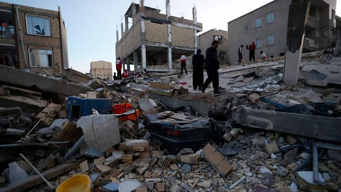 People including rescue personnel conduct search and rescue work following a 7.3-magnitude earthquake at Sarpol-e Zahab