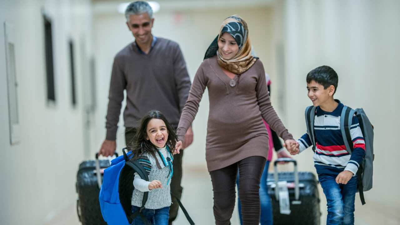 A family of four arriving into a new country. 