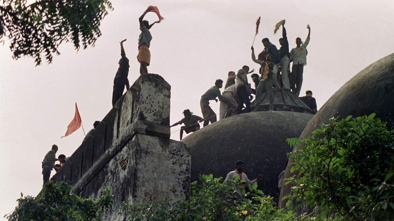 In this file photograph taken on December 6, 1992 Hindu youths clamour atop the 16th century Muslim Babri Mosque.