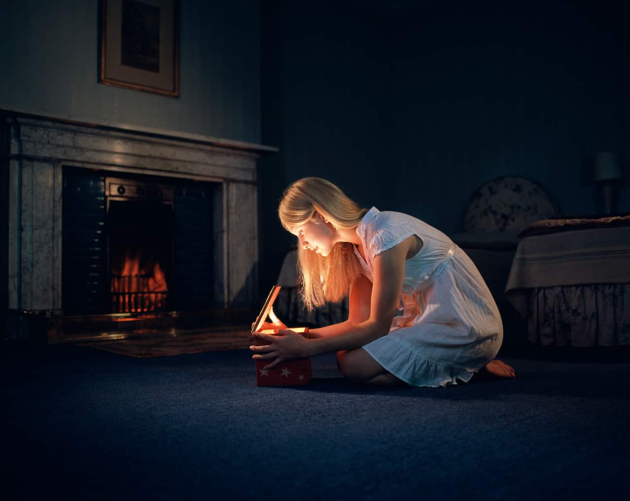 Teenage girl (14-15) looking into box