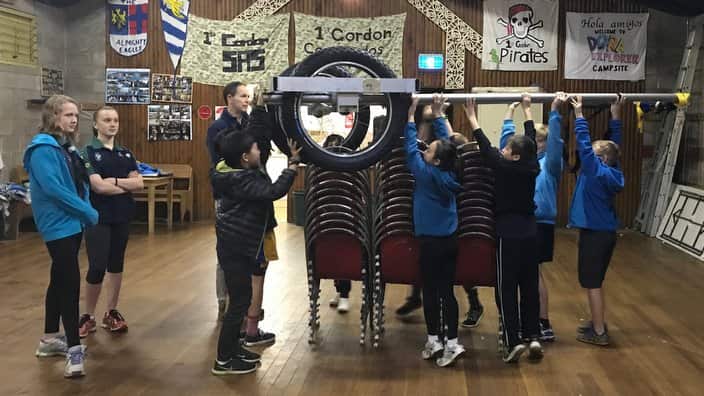 Scouts from 1st Gordon scout group lifting Sarah Hyde's cart