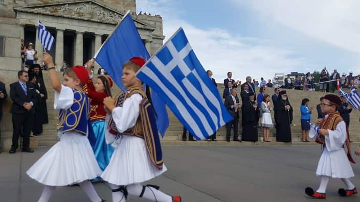Greek Australian kids marching in front of Melbourne's Shrine of Remembrance on Greek National Day
