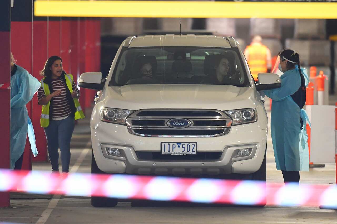 Healthcare employees are seen at work in a Covid-19 testing facility at Northland shopping centre in Melbourne