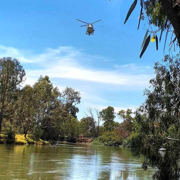A helicopter hovers over Murray River to search for Nepali man Bigul Pandit
