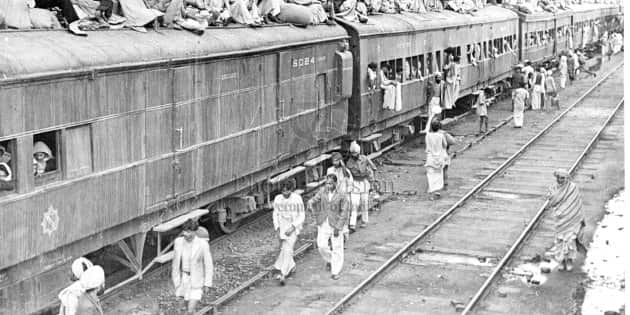 APO/February,54,A31dA refugee special train at Ambala Station. The carriages are full and the refugees seek room on top.