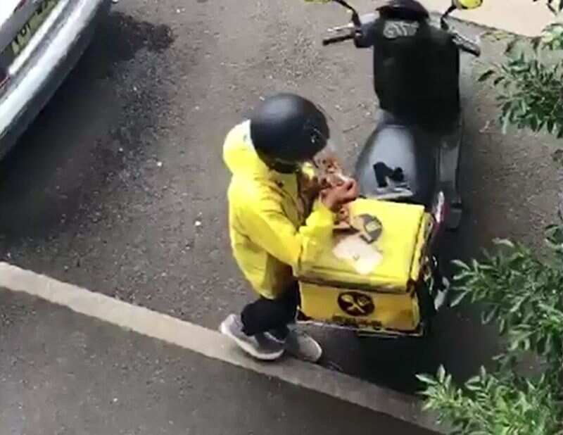 A delivery driver has been caught eating from the order he was delivering.