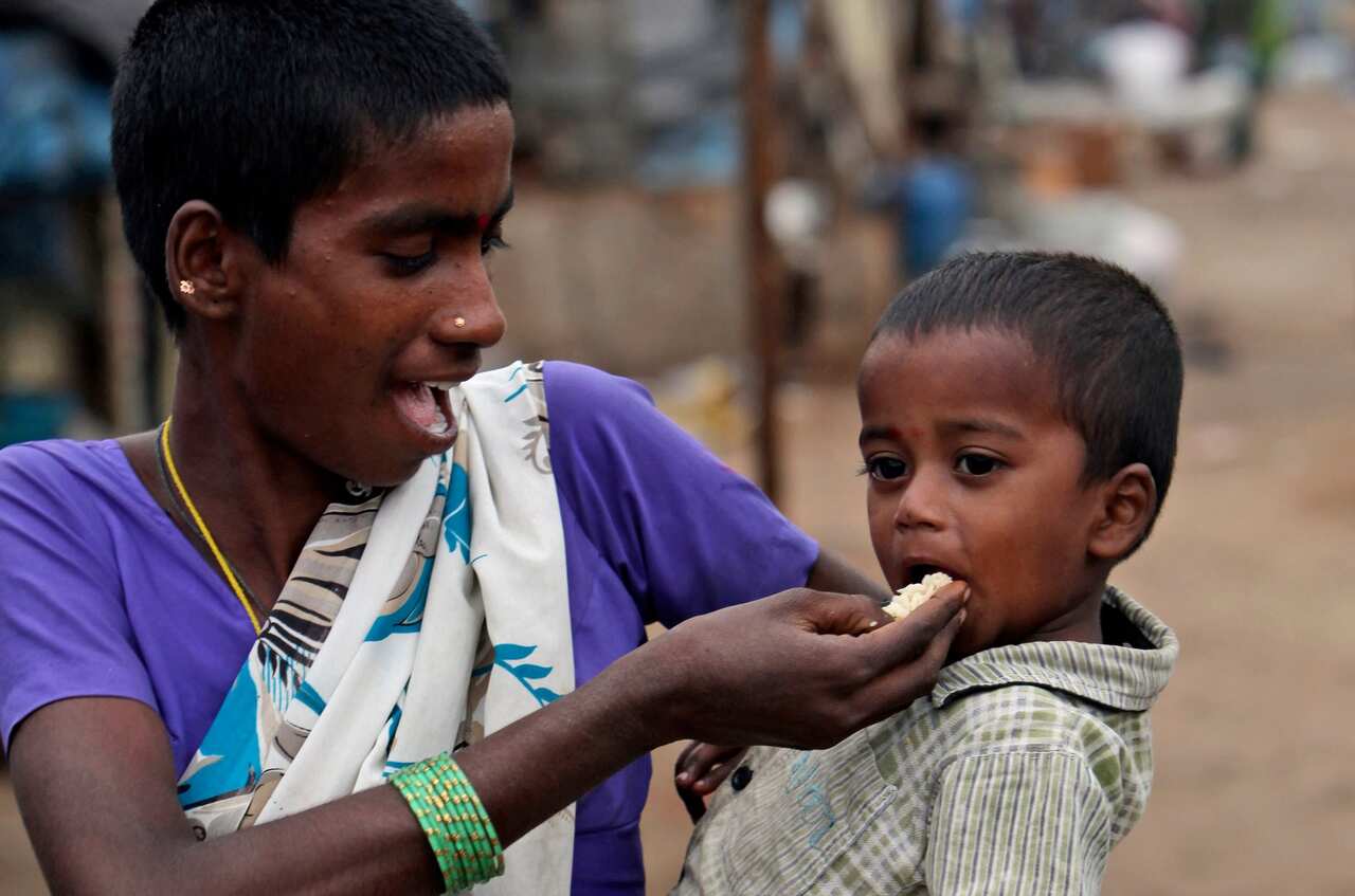 An Indian woman feeds her child at a shanty area in Hyderabad, India, Tuesday, Jan. 10, 2012.