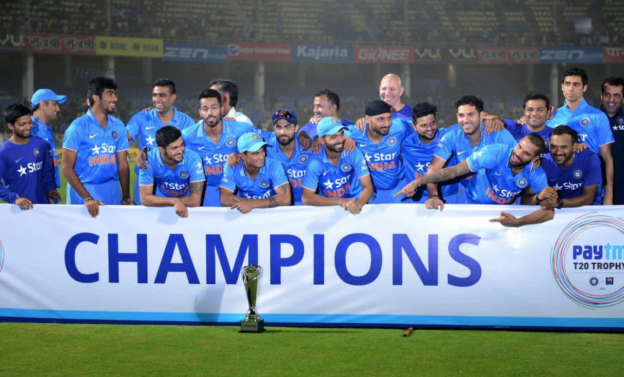 Indian cricket team poses with paytm champions Trophy during the third T20 international match between India and Sri Lanka at the Dr. Y.S. Rajasekhara Reddy ACA-VDCA Cricket Stadium in Visakhapatnam on February 14, 2016. India won the series with 2-1