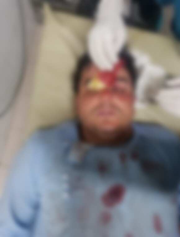 A blurred image of Mr Hashimi receiving medical attention after being shot.