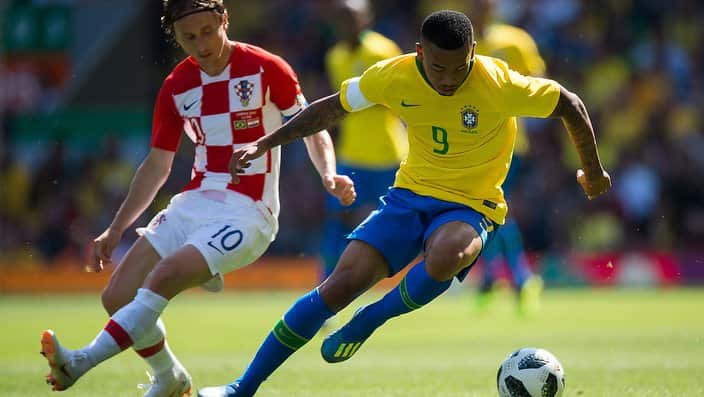 Brazil's Gabriel Jesus (R) in action with Croatia’s Luca Modric (L).