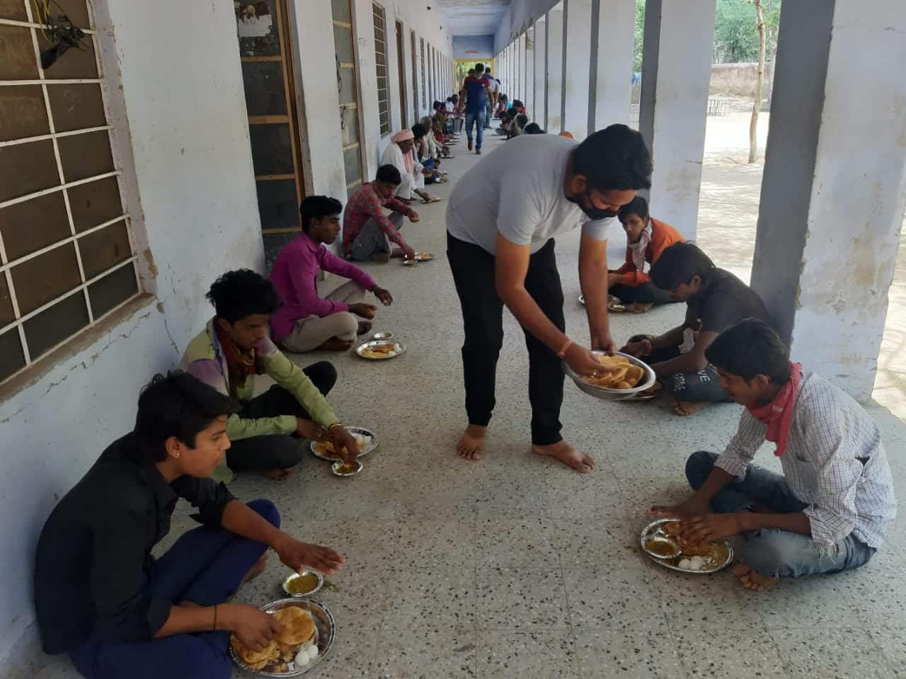 Food is being served to the migrant workers housed in the school in Pansana, district Sikar, Rajasthan India