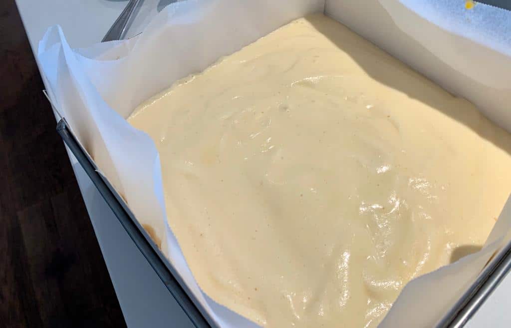 Put the cake mixture into a cake tin with cardboard on 4 sides to prevent burning.