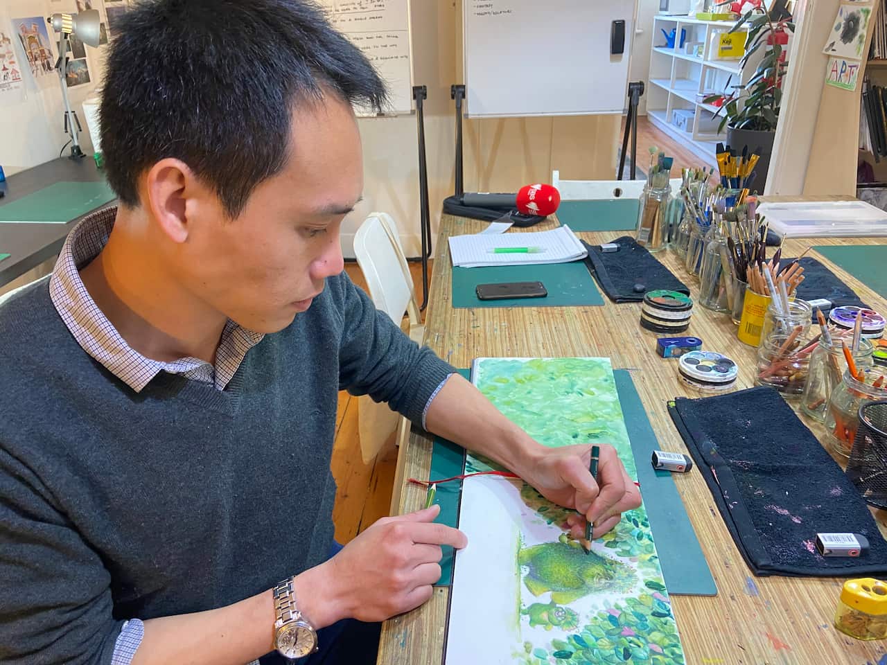 คุณ ตุลย์ สุวรรณกิจ กำลังลงสีผลงานที่เขาวาด