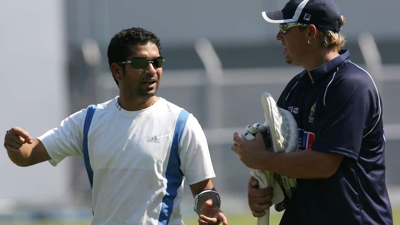 Sachin Tendulkar of India speaks with Shane Warne of Australia during training at Brabourne Stadium on September 29, 2004 in Mumbai.