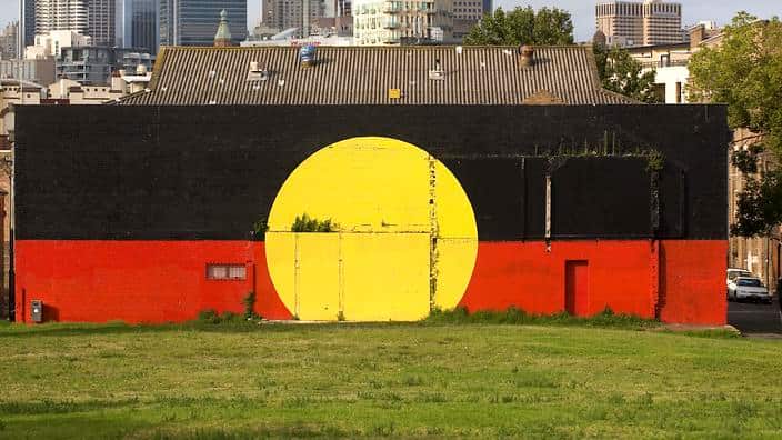 File photo: An Aboriginal flag mural in Redfern, Sydney, Australia, Monday, Jan. 28, 2008. (AAP)