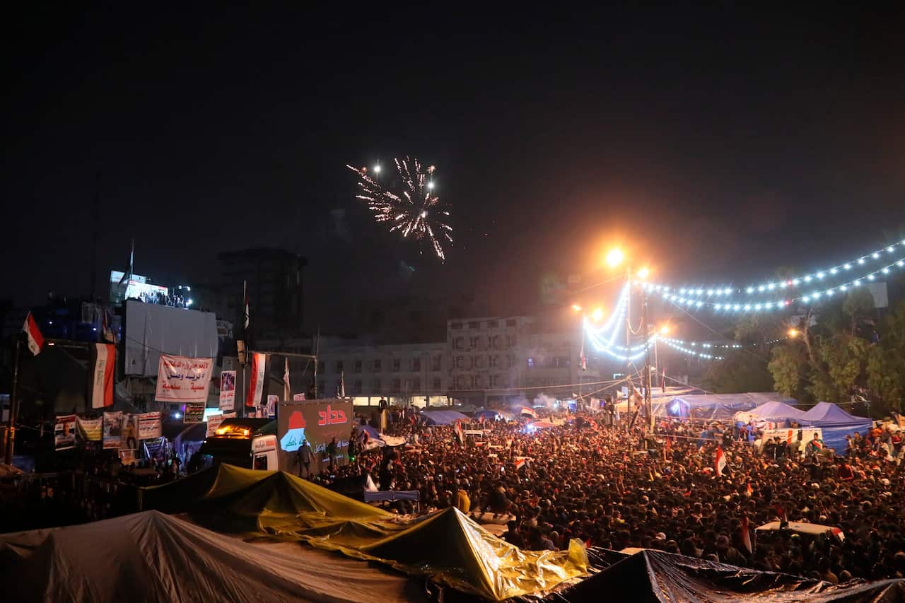 Anti-government protesters shoot fireworks in Tahrir Square following an announcement by Iraqi Prime Minister Adel Abdul-Mahdi, would be resigning