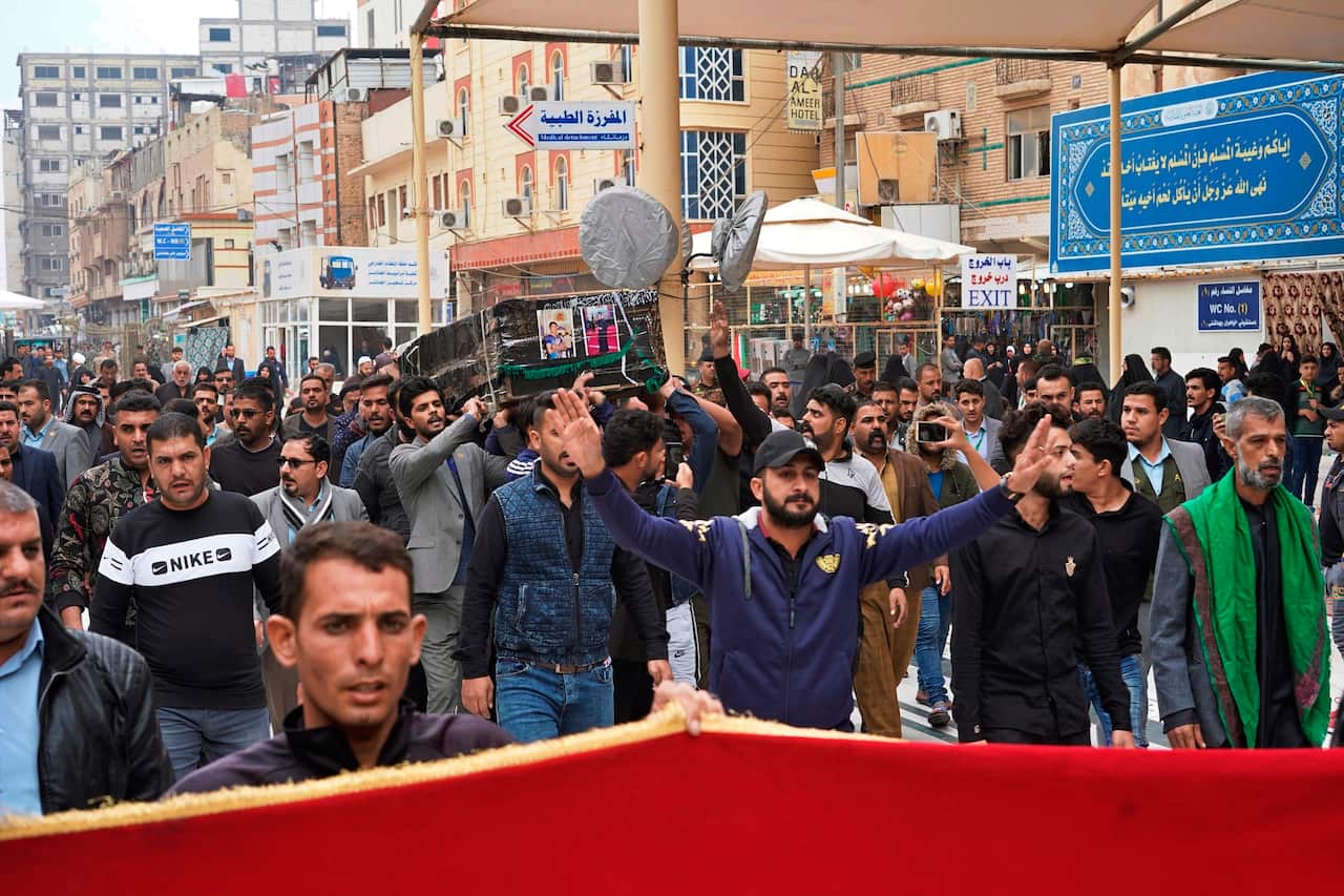 Mourners carry the coffin of Mehdi Kadim, 17, a protester killed during anti-government demonstrations, during his funeral in Najaf, Iraq, Friday, Nov. 29, 2019