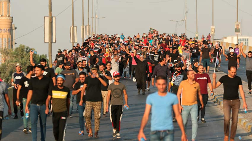 Anti-government protesters walk towards the protest site area during a demonstration in Baghdad, Iraq.