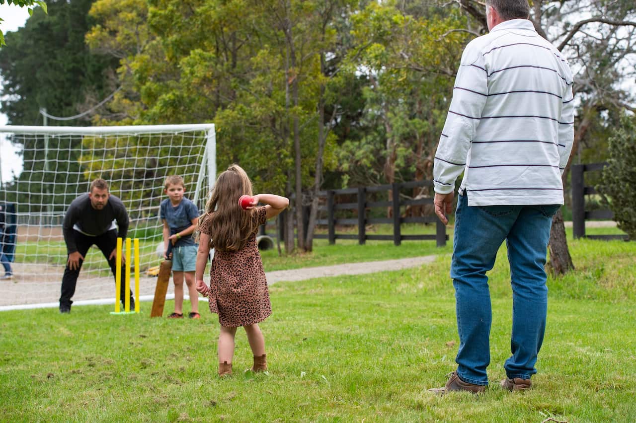 Australian Family Playing Sport in the Backyard