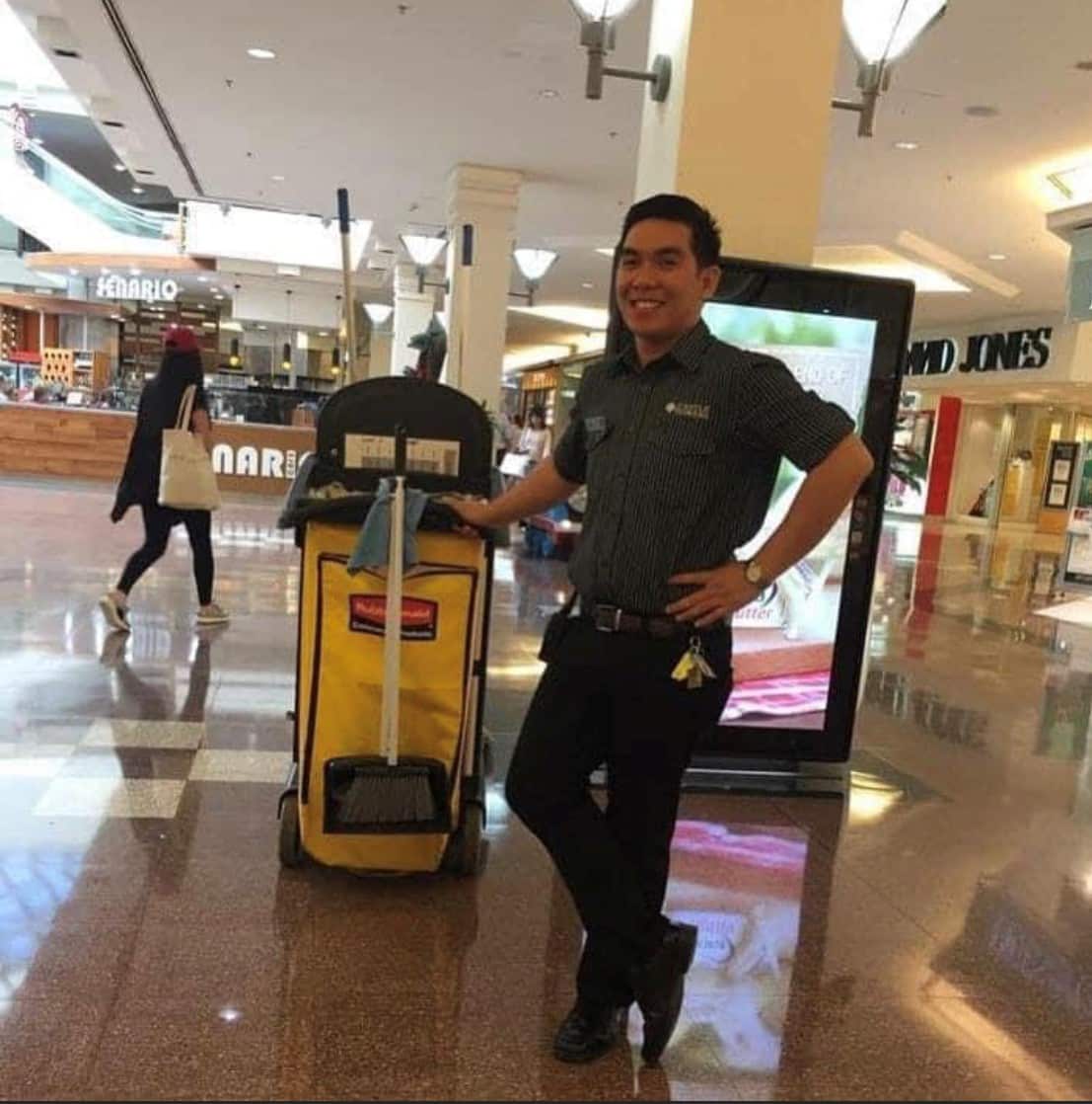 John strikes a pose while on break working as a cleaner in a Sydney mall in 2013.