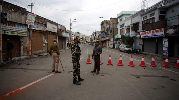 Jammu and Kashmir policemen stand guard on the deserted street during fourth day of curfew in Jammu, the winter capital of Kashmir, India, 18 February 2019.