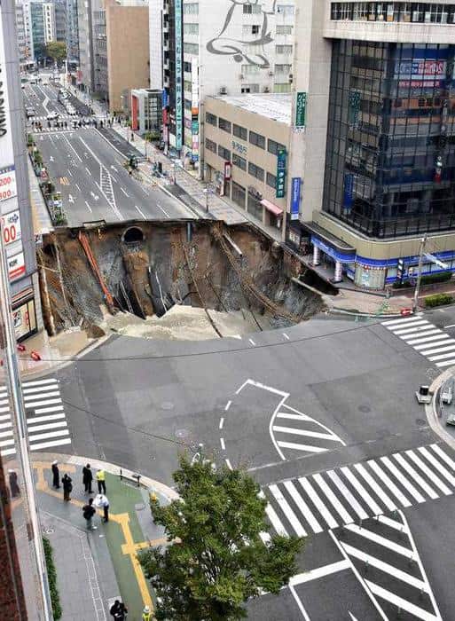 A massive sinkhole has opened up in the middle of the business district in Fukuoka, southern Japan.