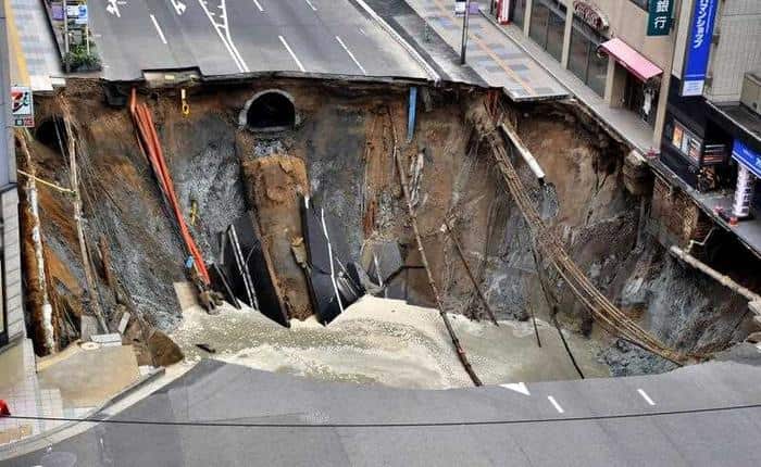 A huge sinkhole is pictured at a crossing near JR Hakata Station in downtown Fukuoka. 