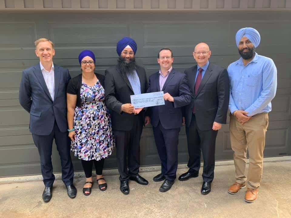 Julian Hill MP, Shayne Neumann MP, with Jatinder Kaur (manager Sahara House) and members from the Brisbane Sikh temple receiving a donation of $8887 from the CEO of Key Assets in December 2018