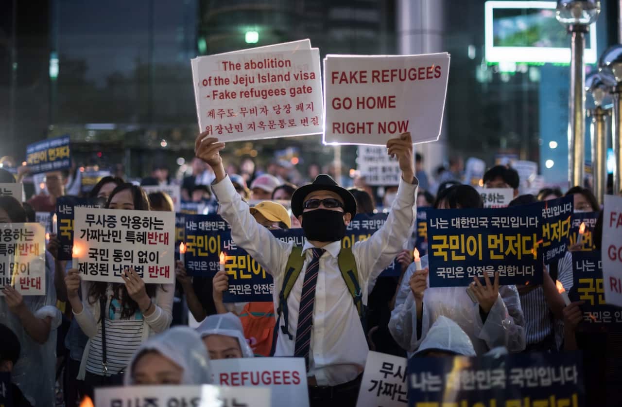 Anti-immigration activists attend a protest against a group of asylum-seekers from Yemen, in Seoul on June 30, 2018