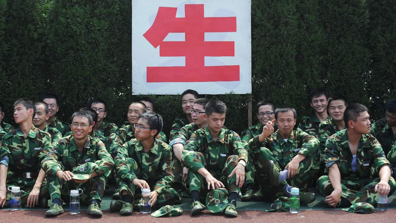 Chinese first-year university students taking a break as they undergo a one-month military training.
