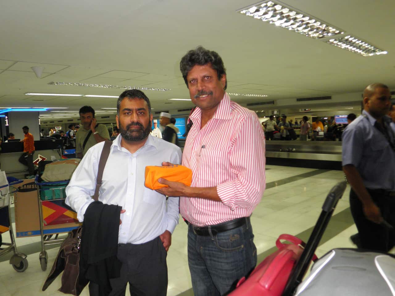Kapil Dev and Harmel Uppal at New Delhi airport, after collecting the ashes and flying from Melbourne on July 26