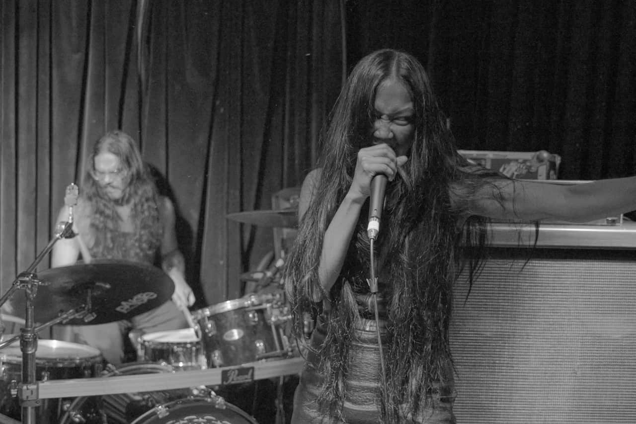 Rama Parwata, the curator for The Make It Up Club performing in metal band Kilat with its principal vocalist, Karina Utomo.