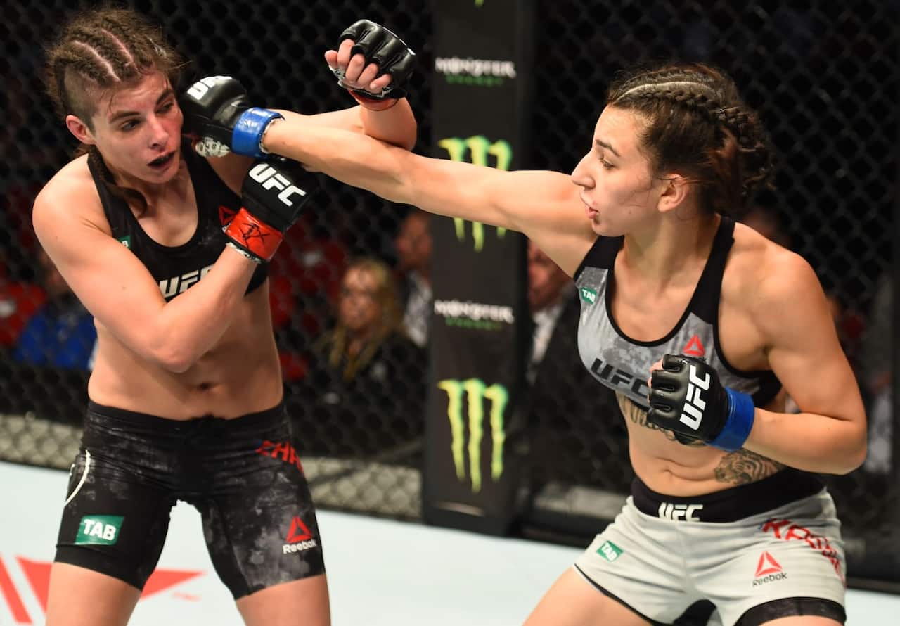 Nadia Kassem punches Alex Chambers of Australia in their women's strawweight bout during the UFC Fight Night on Nov 19, 2017.