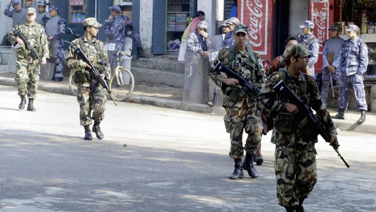 Nepalese soldiers patrol a street near the Royal Palace in Kathmandu, 01 February 2005, after King Gyanendra dissolved a coalition government.