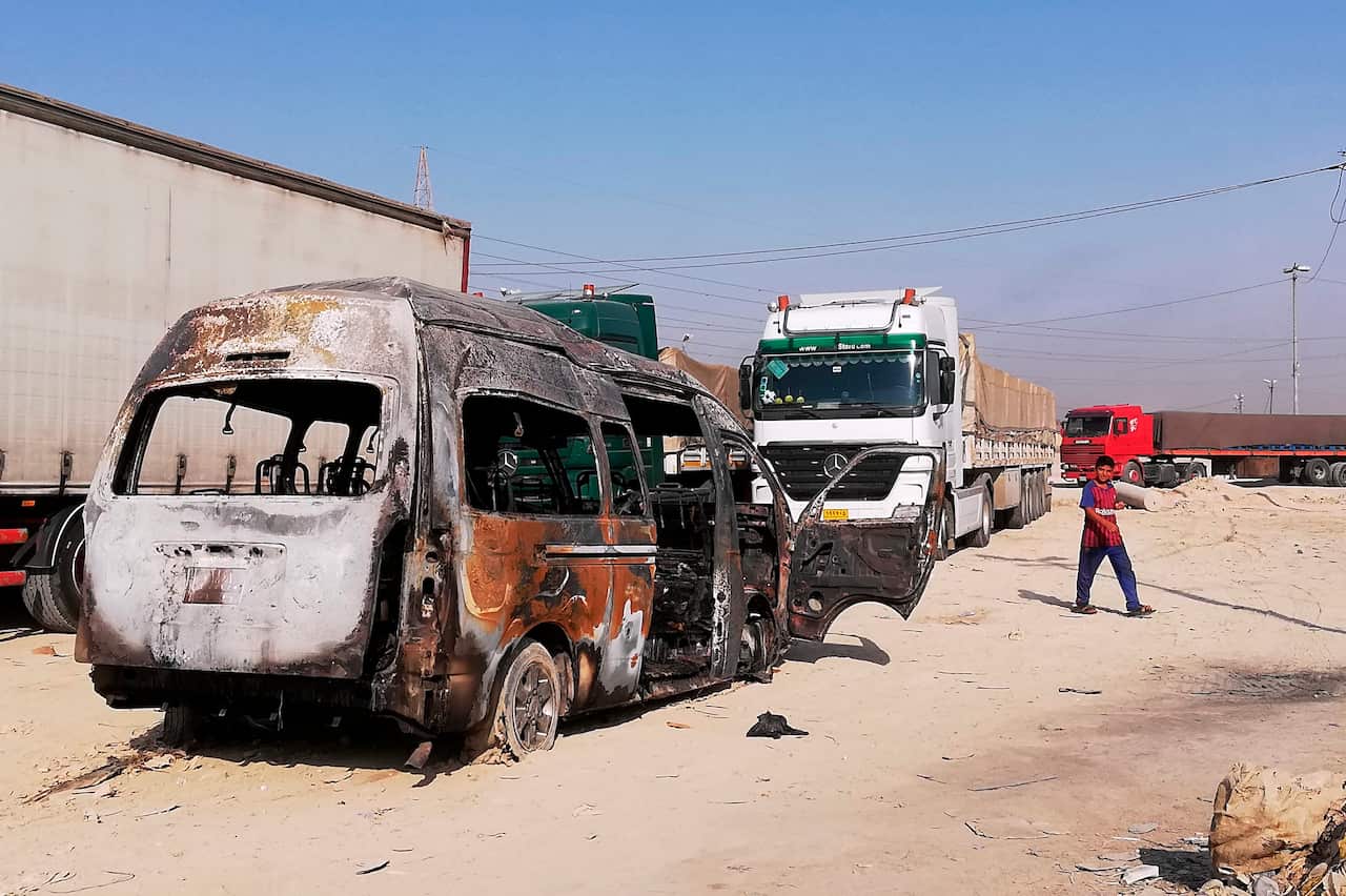 A destroyed minibus sits near an Iraqi army checkpoint, about 10 kilometers (6 miles) south of Karbala, Iraq, Saturday, Sept. 21, 2019. A bomb exploded on a minibus packed with passengers outside the Shiite holy city of Karbala Friday night, killing and w