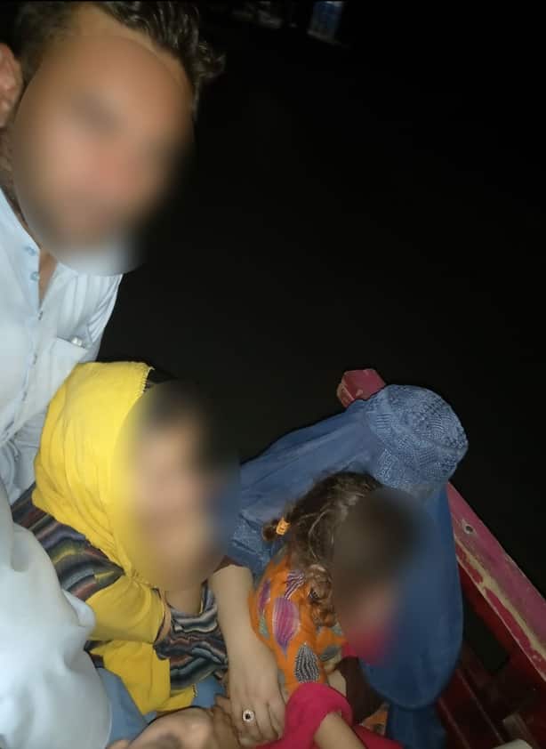 Khalid with his family at the back of a car while shifting houses before the Taliban entered Jalalabad city, the capital of Nangarhar.