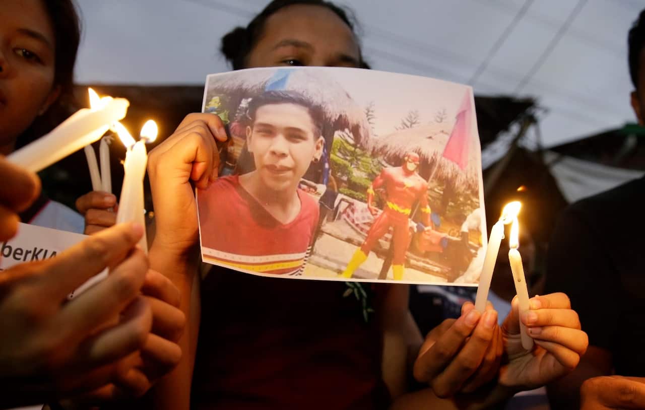 A supporter of Kian delos Santos attends a protest outside the police station where three policemen involved in Kian's killing were assigned