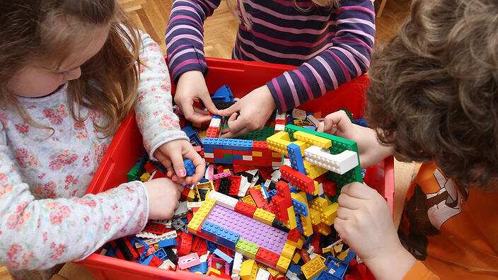 Children playing with LEGO building bricks.