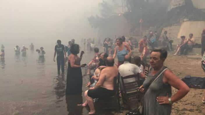 Greece Wildfires, People go to the beach 