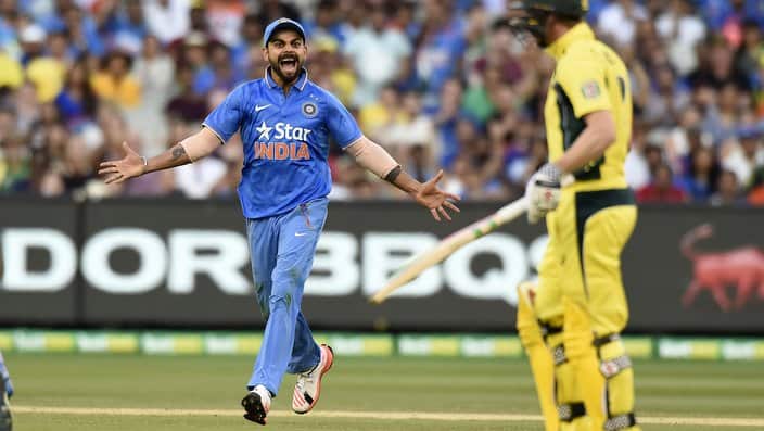 India's Virat Kohli, left, celebrates the wicket of Australia's George Bailey, right, during their one day international cricket match in Melbourne, Australia, Sunday, Jan. 17, 2016. (AP Photo/Andy Brownbill)