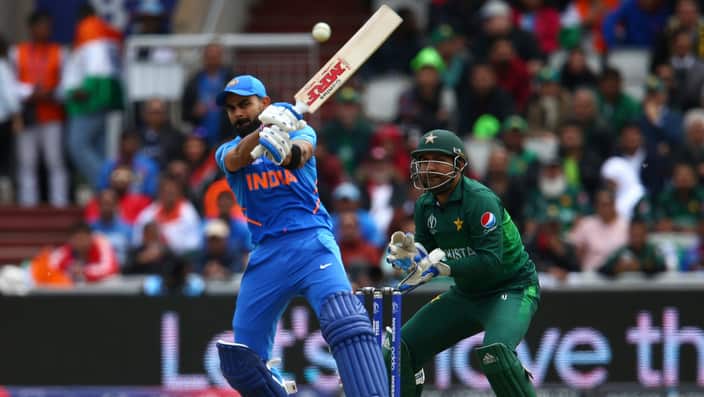 India's captain Virat Kohli, left, plays a shot under the watch of Pakistan's captain Sarfaraz Ahmed during the Cricket World Cup match between India and Pakistan at Old Trafford in Manchester, England, Sunday, June 16, 2019. (AP Photo/Dave Thompson)