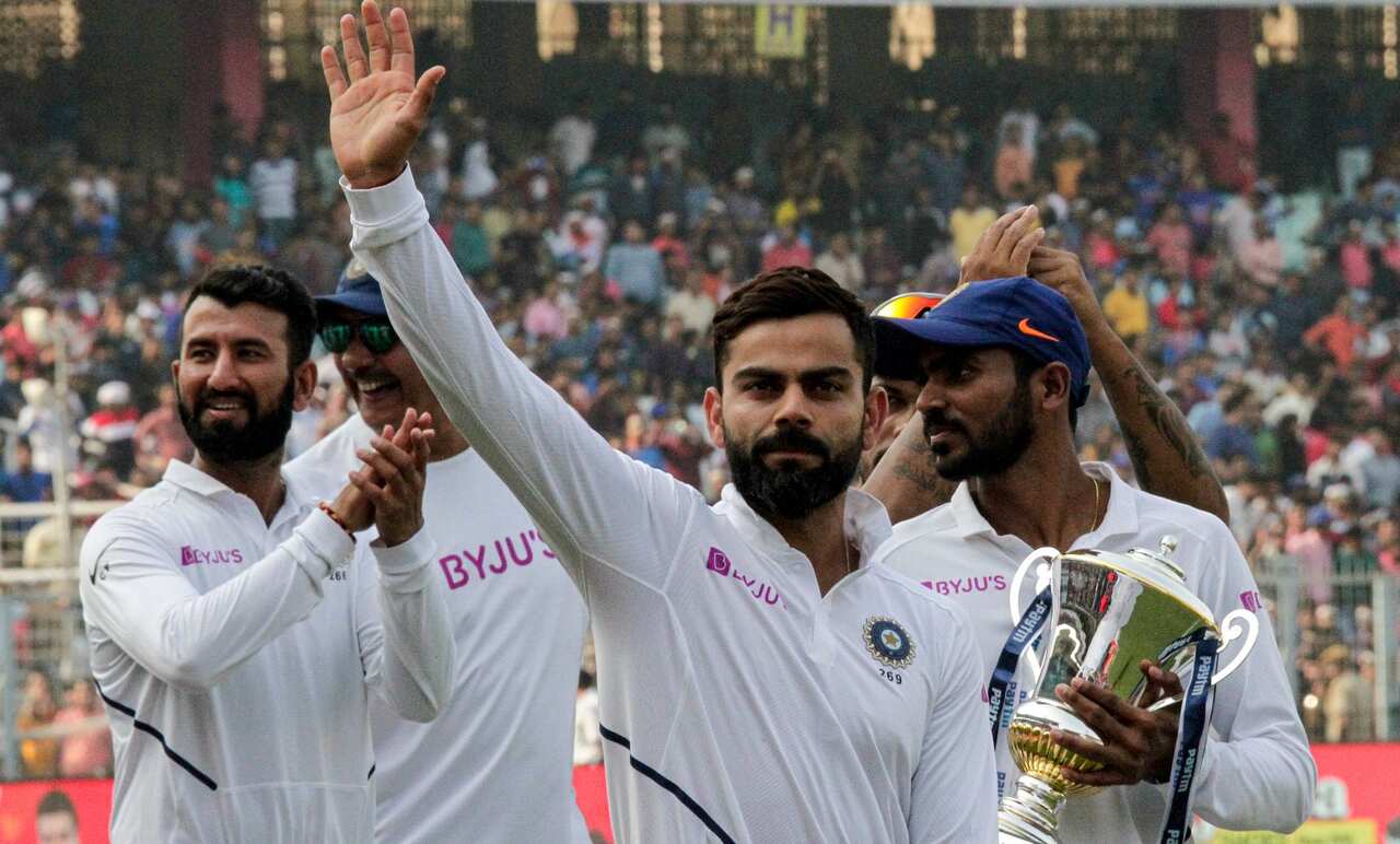 India's captain Virat Kohli gestures to spectators as he leads his team in a victory lap after winning the second match and test series against Bangladesh in Kolkata, India, Sunday, Nov. 24, 2019. (AP Photo/Bikas Das)